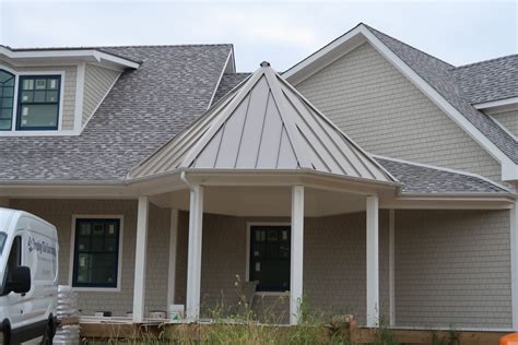 white house with a champagne metal roof|white house with metal roof.